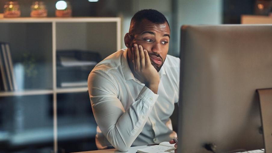 
		Man sitting tired at his desk
	